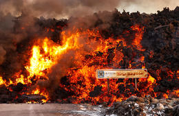 A few street lamps at the end of the parking lot are still standing, but otherwise, all of the parking lot is under lava.