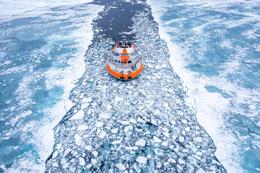 Tara Polar Station sailing through a channel in the ice.