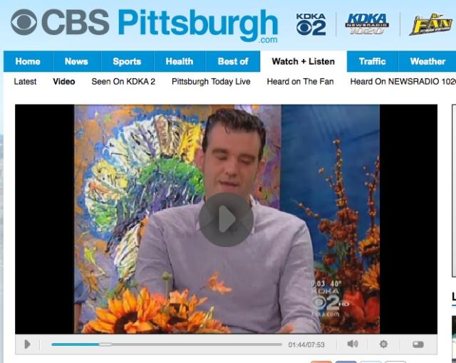 Archived screenshot of a video player on CBS pittsburgh's website with a picture of Stefán Karl in front of a Thanksgiving themed painting behind him.