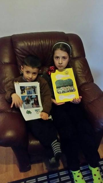 Kevi, aged three, and his sister Klea clutching their memento …
