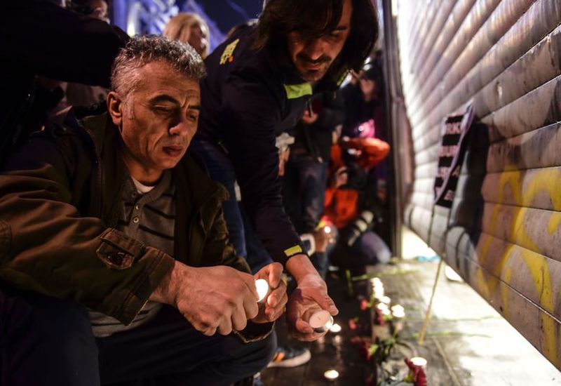 People light candles at the site of the blast.
