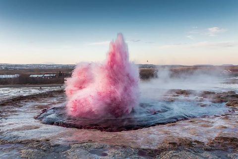 The geysir Strokkur as you've never seen it before: a bright shade of pink.