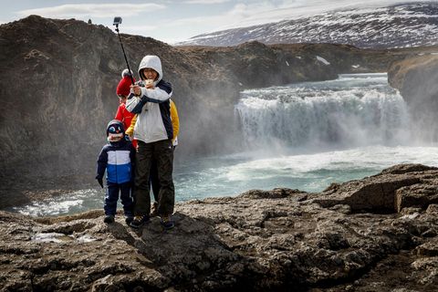 Tourists by Goðafoss waterfall, North Iceland.