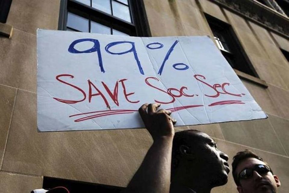 A member of the Occupy Wall St movement holds a sign aloft while demonstrating outside …