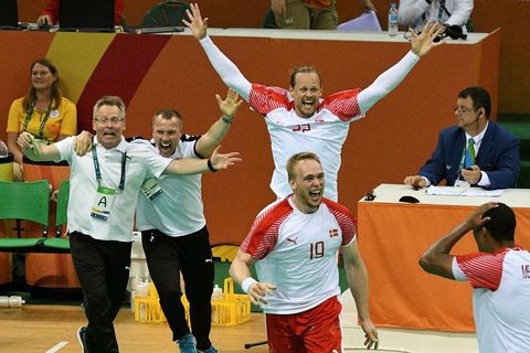 Guðmundur Guðmundsson (left) and the Danish players celebrating their victory.