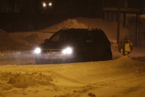 If your kids are at school they will be perfectly fine at classes there until the weather calms down. Don't venture out by car to pick them up.