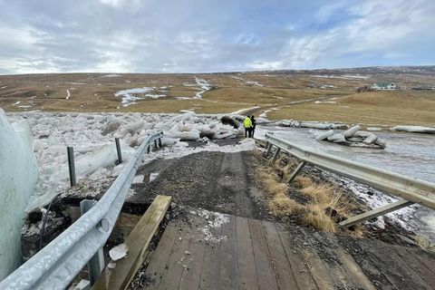 Here you can see where the bridge has been pushed aside by the ice flood taking the road apart.