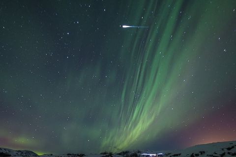 An Iridium flare is seen here in the upper part of the photograph, to the left of the Northern Lights.