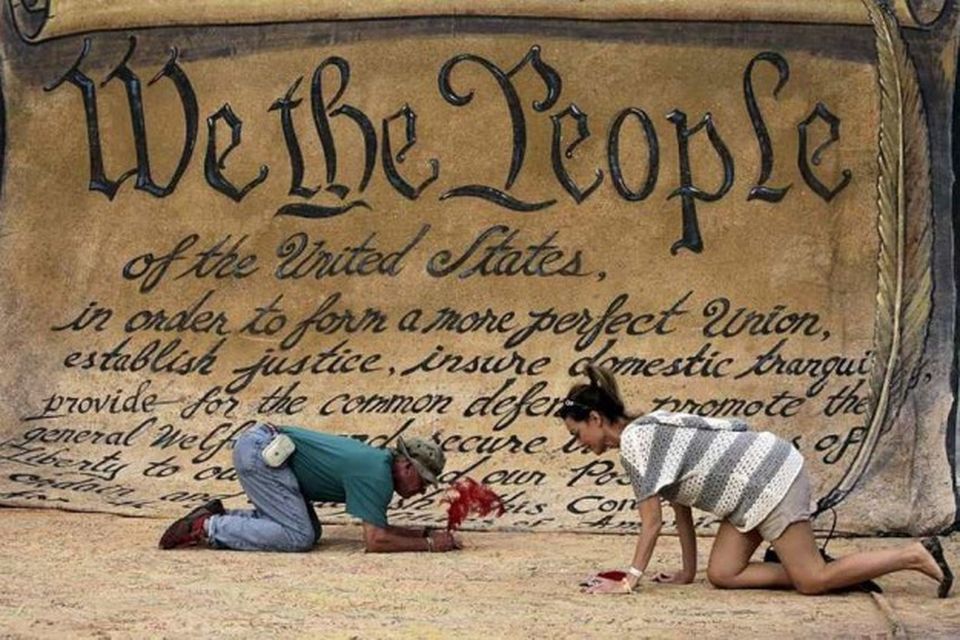 REFILE - CLARIFYING CAPTIONPeople sign a huge copy of the U.S. Constitution at the Occupy …