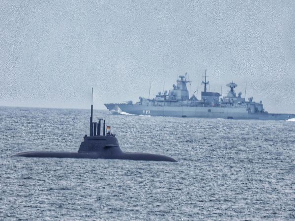 A German submarine in Faxaflói Bay. A warship can be seen in the background.