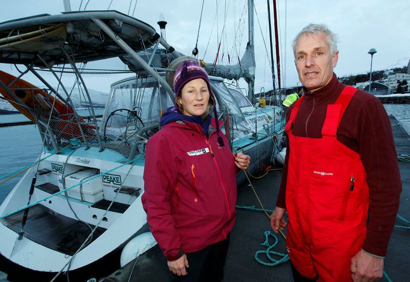 Dario Schwoerer and Sabine by the sailboat Pachamama, their home for 17 years. They got in danger during the storm.