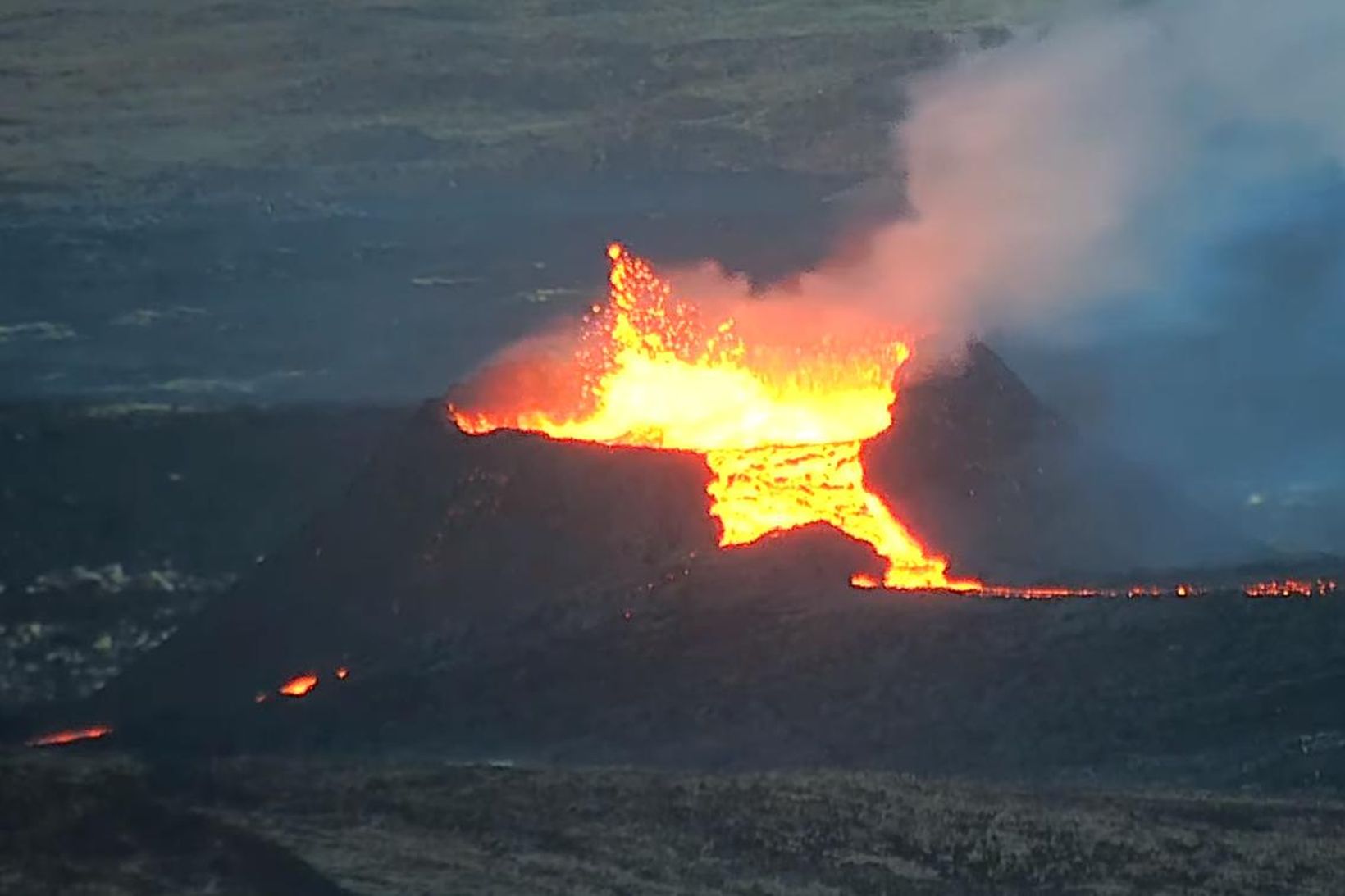 Screenshot from webcam at 20:30. Lava flows over the rim of the crater.