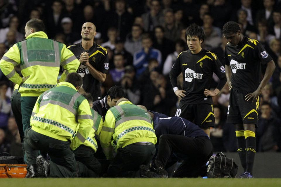 Leikmenn Bolton fylgjast slegnir með þegar Fabrice Muamba fær aðstoð.