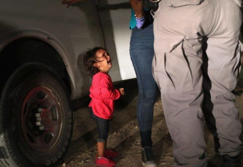 A two year old girl cries  at the US border