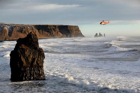 The National Coastguard helicopter searching for the woman today at Reynisfjara .