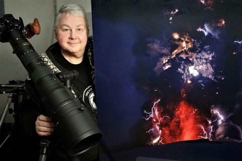 Ragnar Th. Sigurðsson is ready with the camera. He stands beside a photo he took of the 2010 eruption in Eyjafjallajökull.