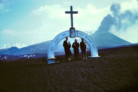 The gate to the Cemetary with the volcano in the background. The gate reads: I will live and you shall live - a saying that thankfully applied to the volcanic eruption in 1973.