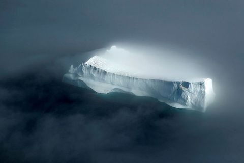 The majestic iceberg, looking mysterious in the fog. It is estimated that only one fifth to one-seventh of it is above sea level.