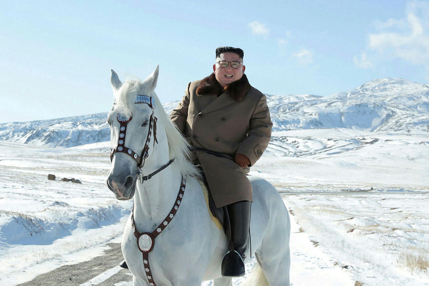 Kim Jong-un á hvítum hesti á snæviþaktri jörð.