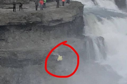 NEVER DO THIS: A tourist risking her life at the powerful Gullfoss falls in South Iceland.