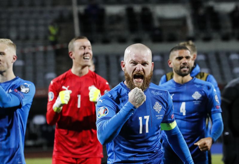 Aron Einar Gunnarsson, captain of the Icelandic team, celebrates victory.