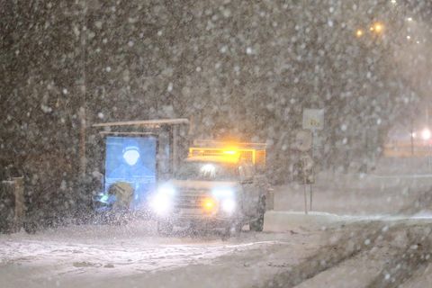 City worker emptying trashcans in the Hlíðar district in Reykjavík this morning. Visibility started getting worse around 9 this morning.