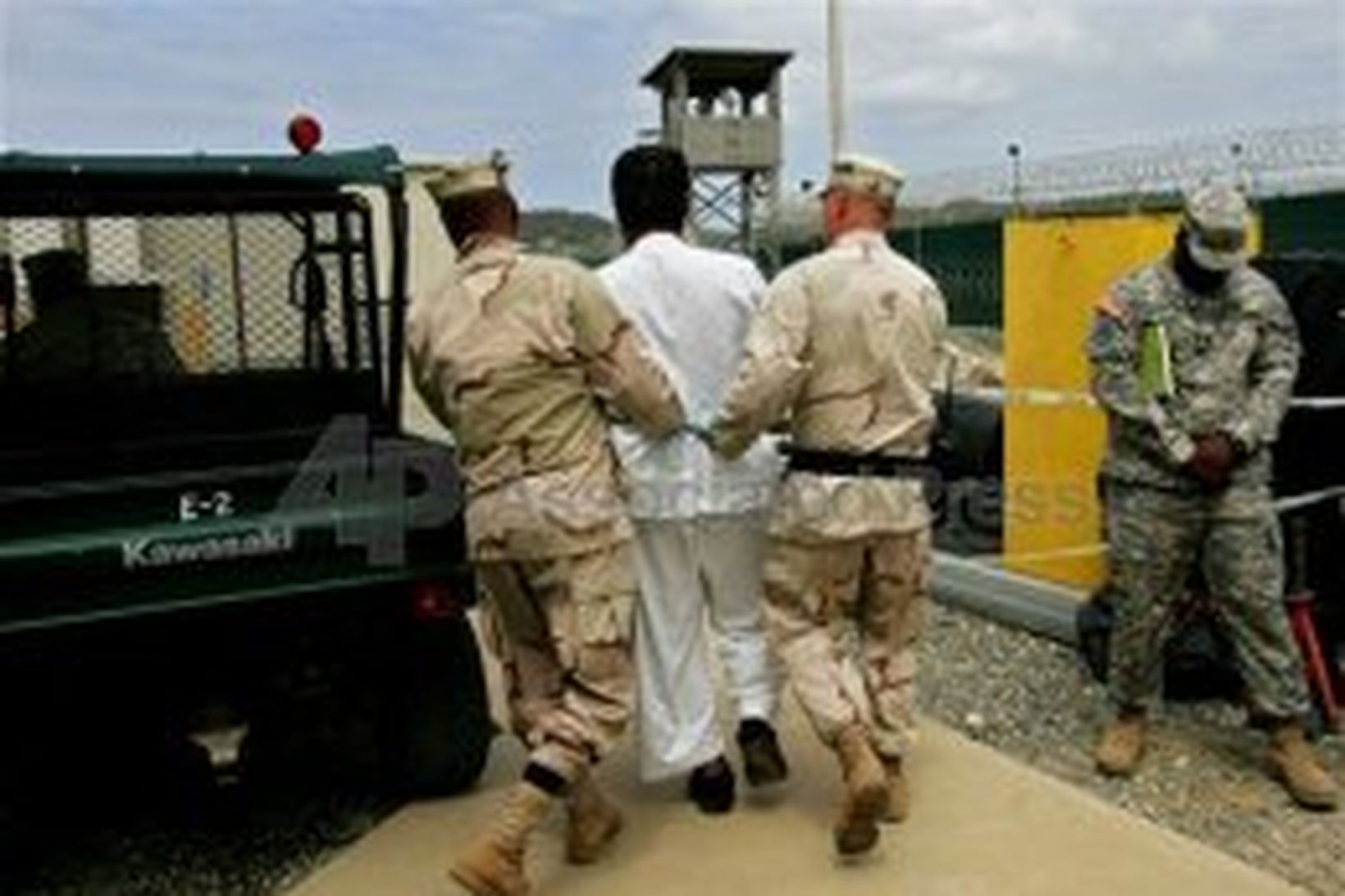 Fanga fylgt af vörðum í Guantánamo fangelsinu.