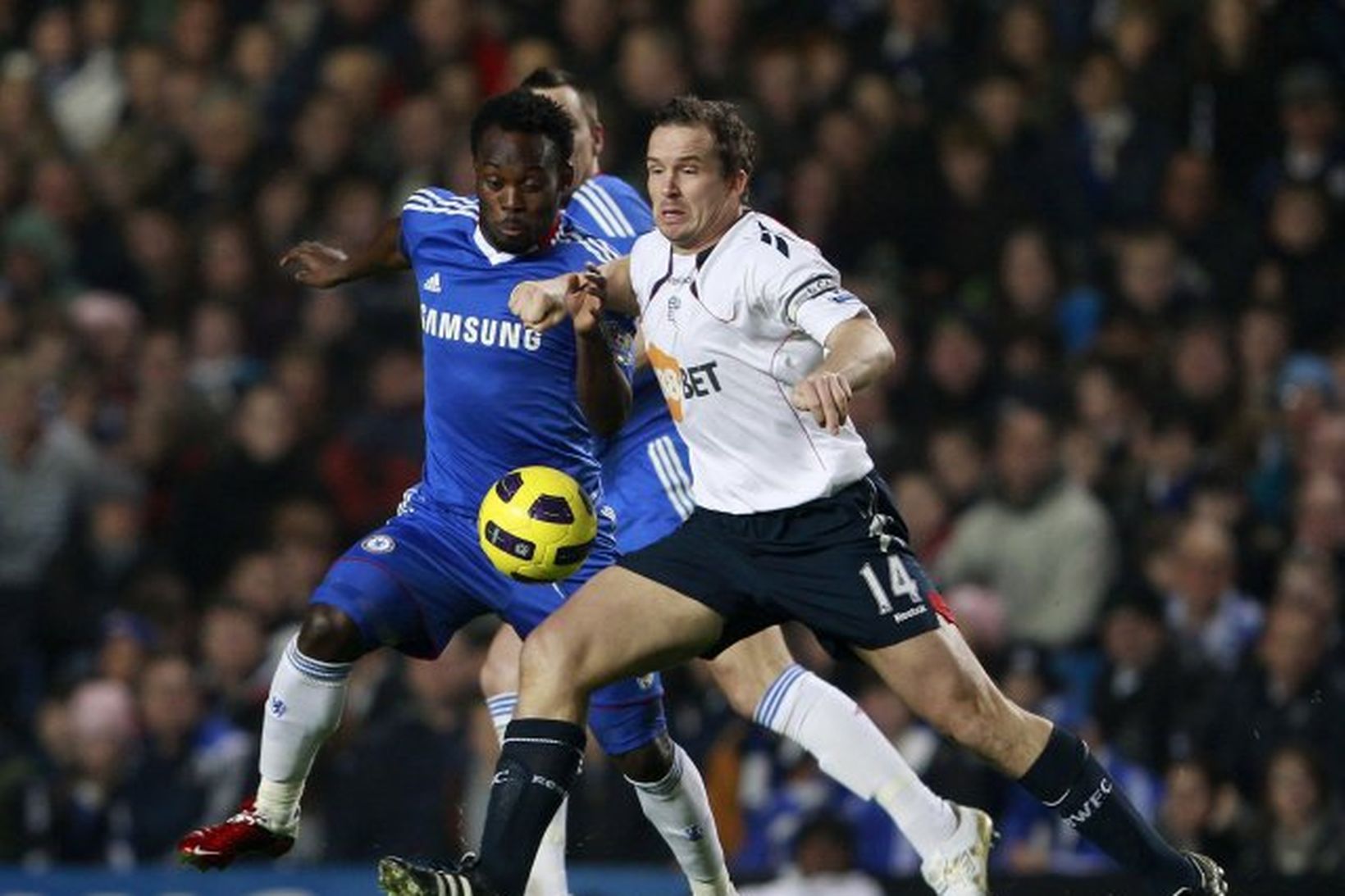 Michael Essien og Kevin Davies í baráttunni á Stamford Bridge …