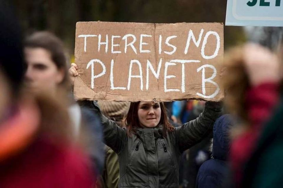A participant holds a sign reading "There is no Planet B" during the "Global Climate …