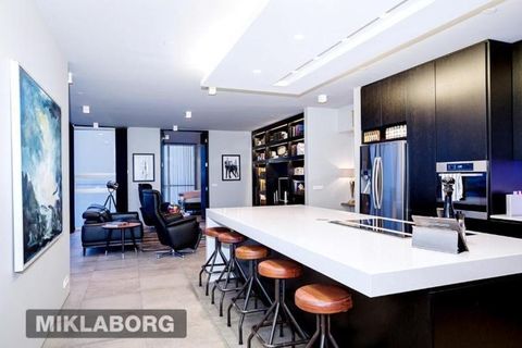 The kitchen features dark lacquered oak and bar-style kitchen table.