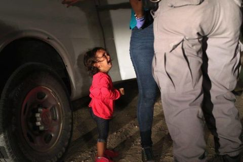 A two year old girl cries  at the US border