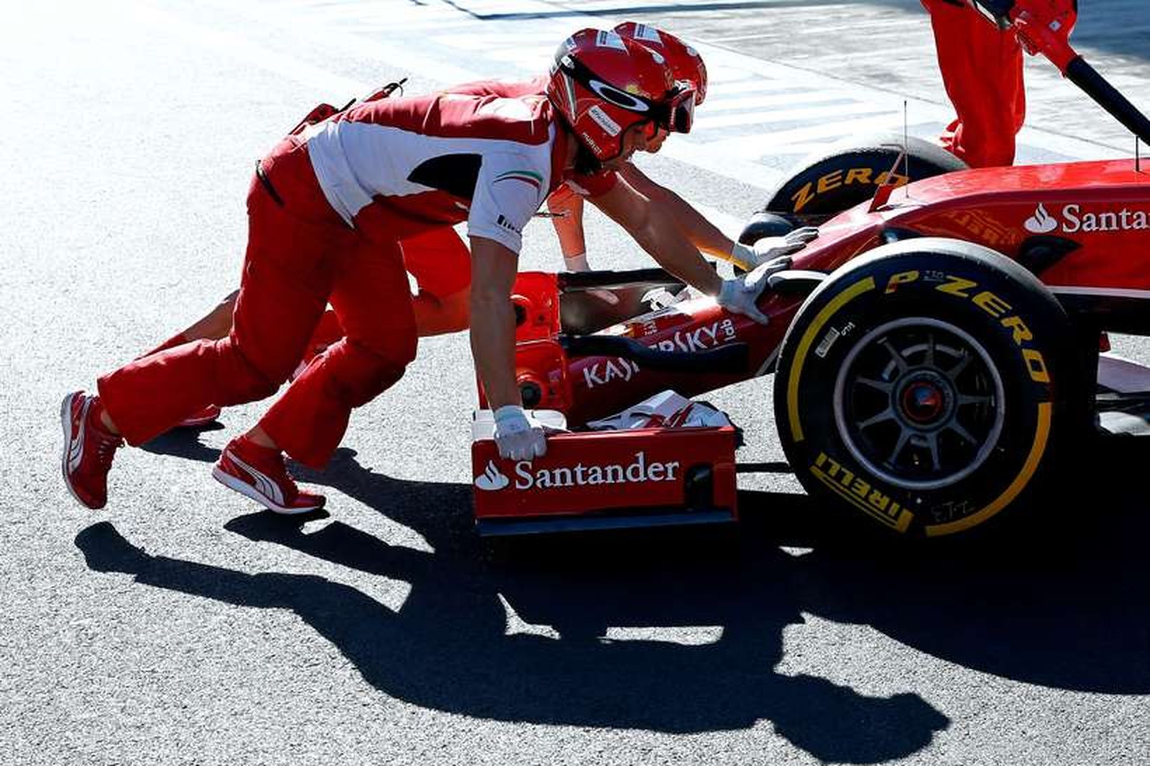 Liðsmenn Ferrari ýta bíl Räikkönen inn í bílskúr í sjotsí.
