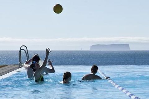 The beautiful views from the pool at Hofsós, North Iceland with Drangey island rising from the ocean in the distance.