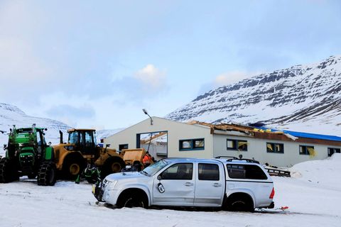 The damaged machinery shed and the pickup truck.