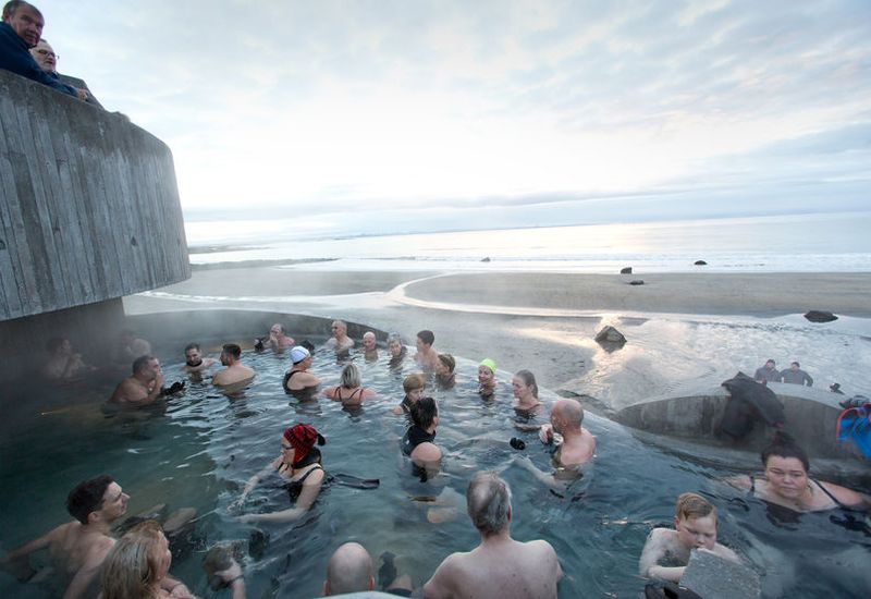 The firsts guests at Guðlaug pool enjoying the warm waters.