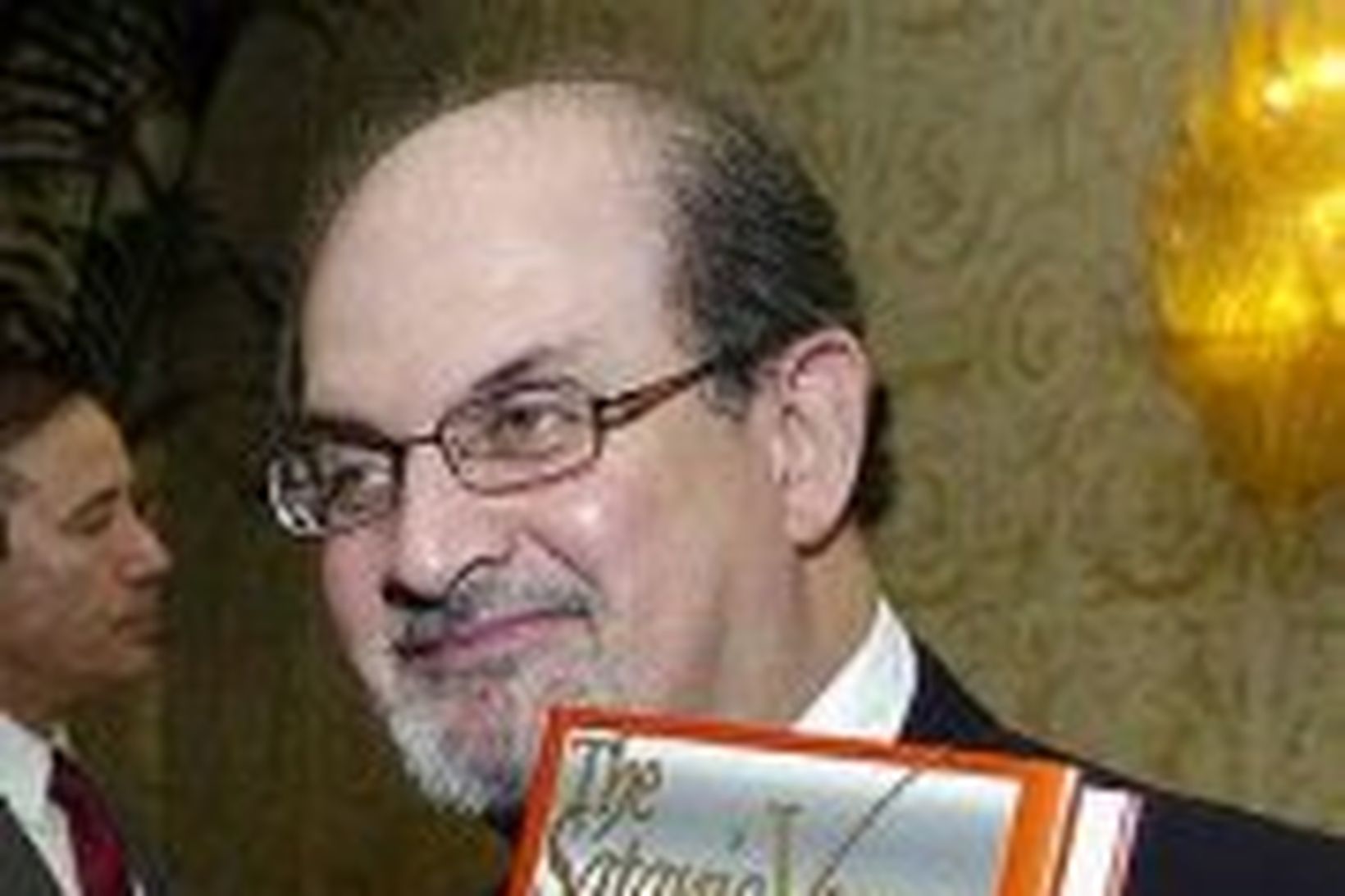 Salman Rushdie með bók sína, Söngva Satans.