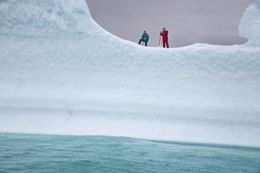 Hans Humes and Heiðar Guðjónsson walking on an iceberg.