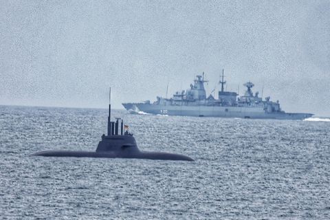 A German submarine in Faxaflói Bay. A warship can be seen in the background.