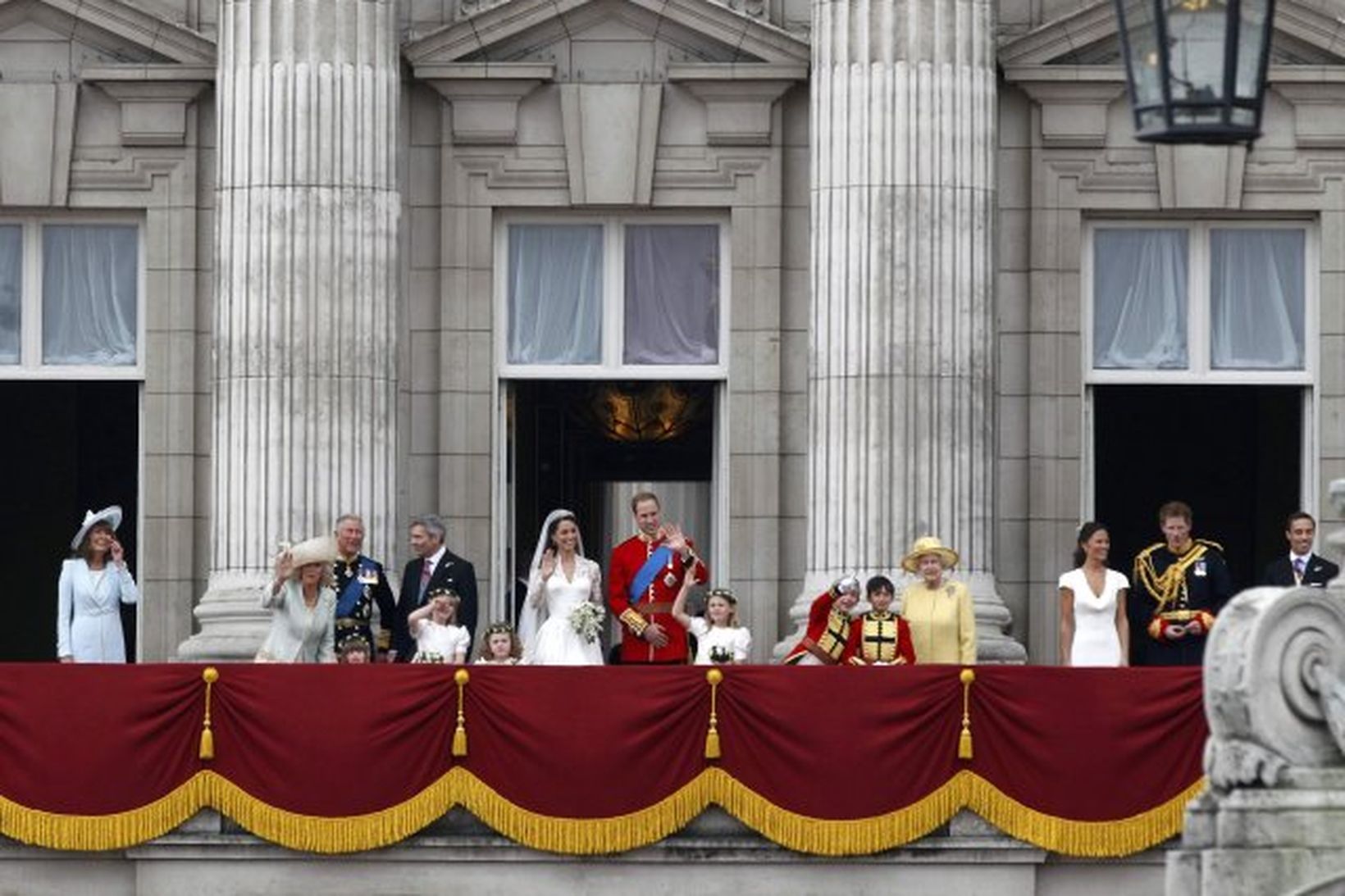 Vilhjálmur prins og Kate Middleton veifa mannfjöldanum af svölum Buckingham-hallar.