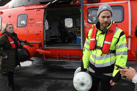 Ásgeir Trausti with the bottle, getting ready to board the helicopter.