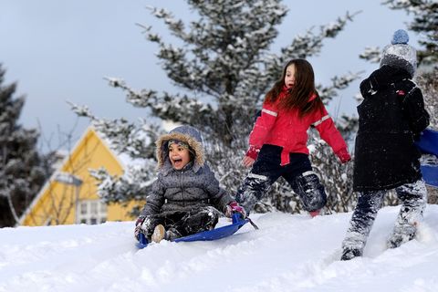 The joy of sledging down snowy slopes.