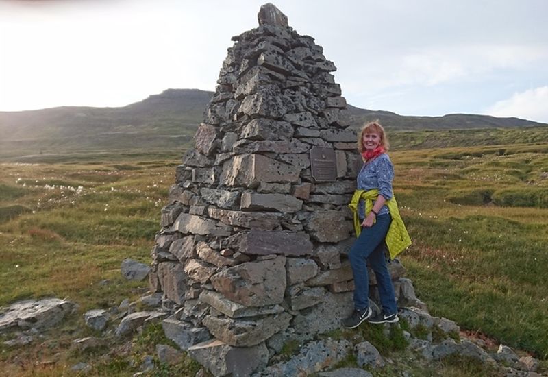 Kristín Steinsdóttir next to the memorial for Dísa, the famous ghost of Seyðisfjörður.