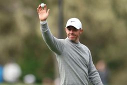 Rory McIlroy veifar til áhorfenda eftir að hann fór holu í höggi í dag.