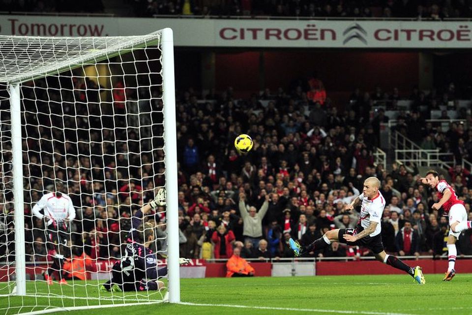 Santi Cazorla kemur Arsenal yfir gegn Liverpool á Emirates í dag.