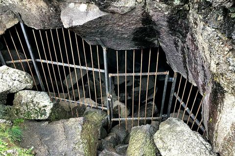 The cave has been closed off with a locked fence and gate.